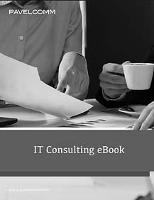 IT-Consulting-Book Two people sit at a desk reviewing papers and charts, with one person holding a cup of coffee. The text on the image reads IT Consulting eBook, PAVELCOMM, and highlights Virtual CIO Services for strategic business growth.