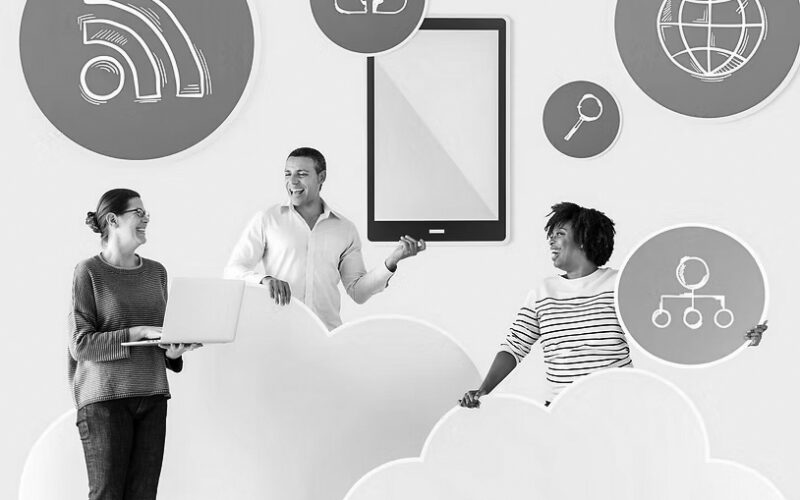 Three people stand among large cloud cutouts, smiling and holding technology-related icons like a tablet and network symbols, representing cloud computing, Unified Communication Services, and digital business connectivity. Blue circular icons float around them.